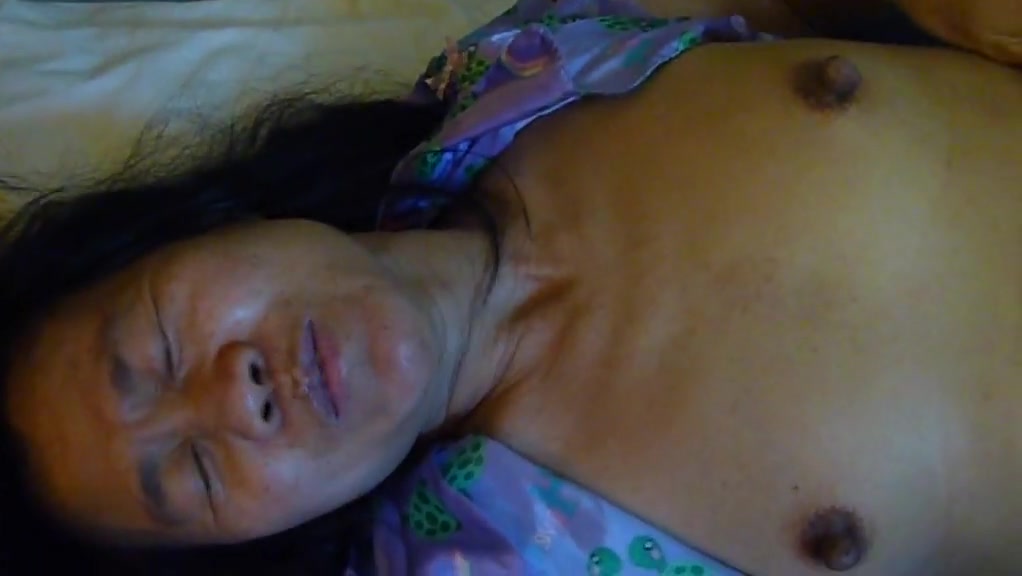 Ugly asian cunt lies on bed